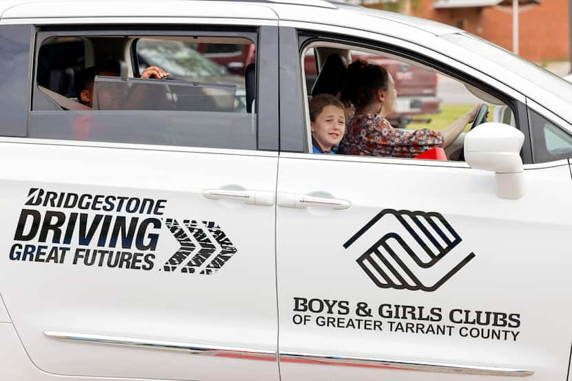 Bristol, 10, takes a ride in a newly donated passenger van at the Boys & Girls Clubs of...
