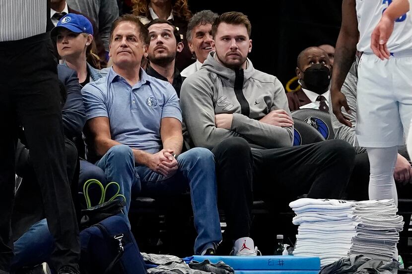 Dallas Mavericks guard Luka Doncic, front right, sits with team owner Mark Cuban, front...