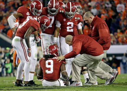 FILE - In this Jan. 9, 2017, file photo, Alabama's Bo Scarbrough is looked at after getting...
