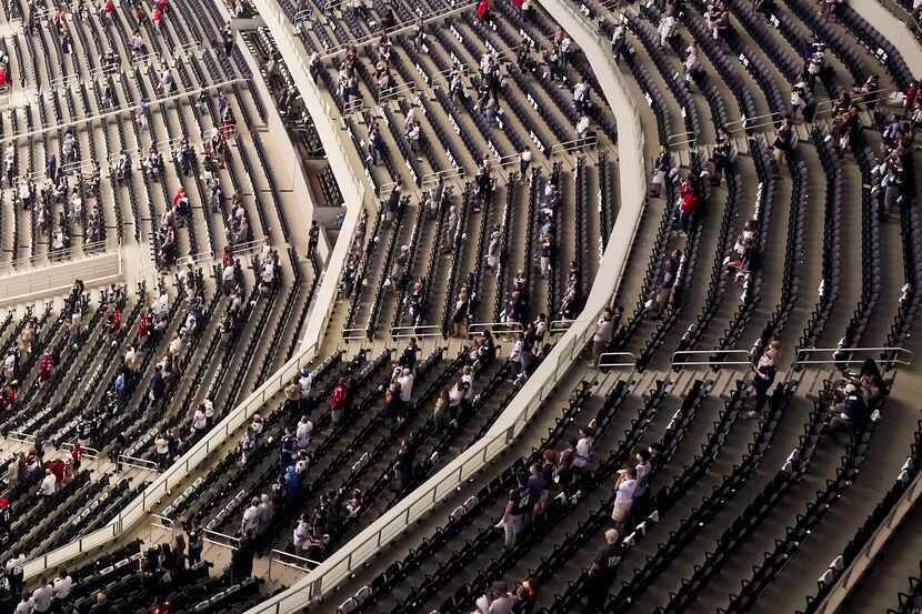 A socially distanced crowd, separated into what team officials described as "pods," stands...