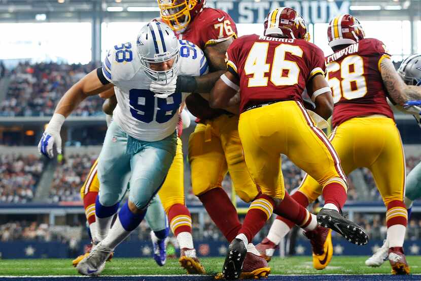 Dallas Cowboys defensive tackle Tyrone Crawford (98) tries to stop Washington Redskins...