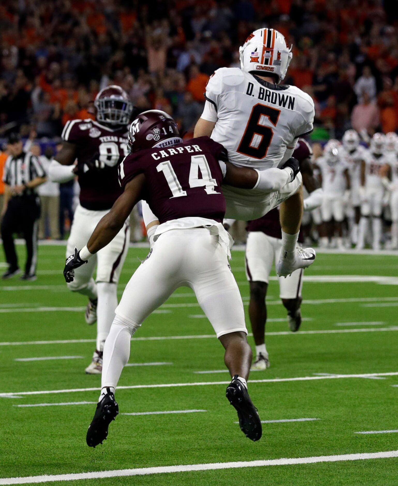 HOUSTON, TEXAS - DECEMBER 27: Dru Brown #6 of the Oklahoma State Cowboys scores on a nine...