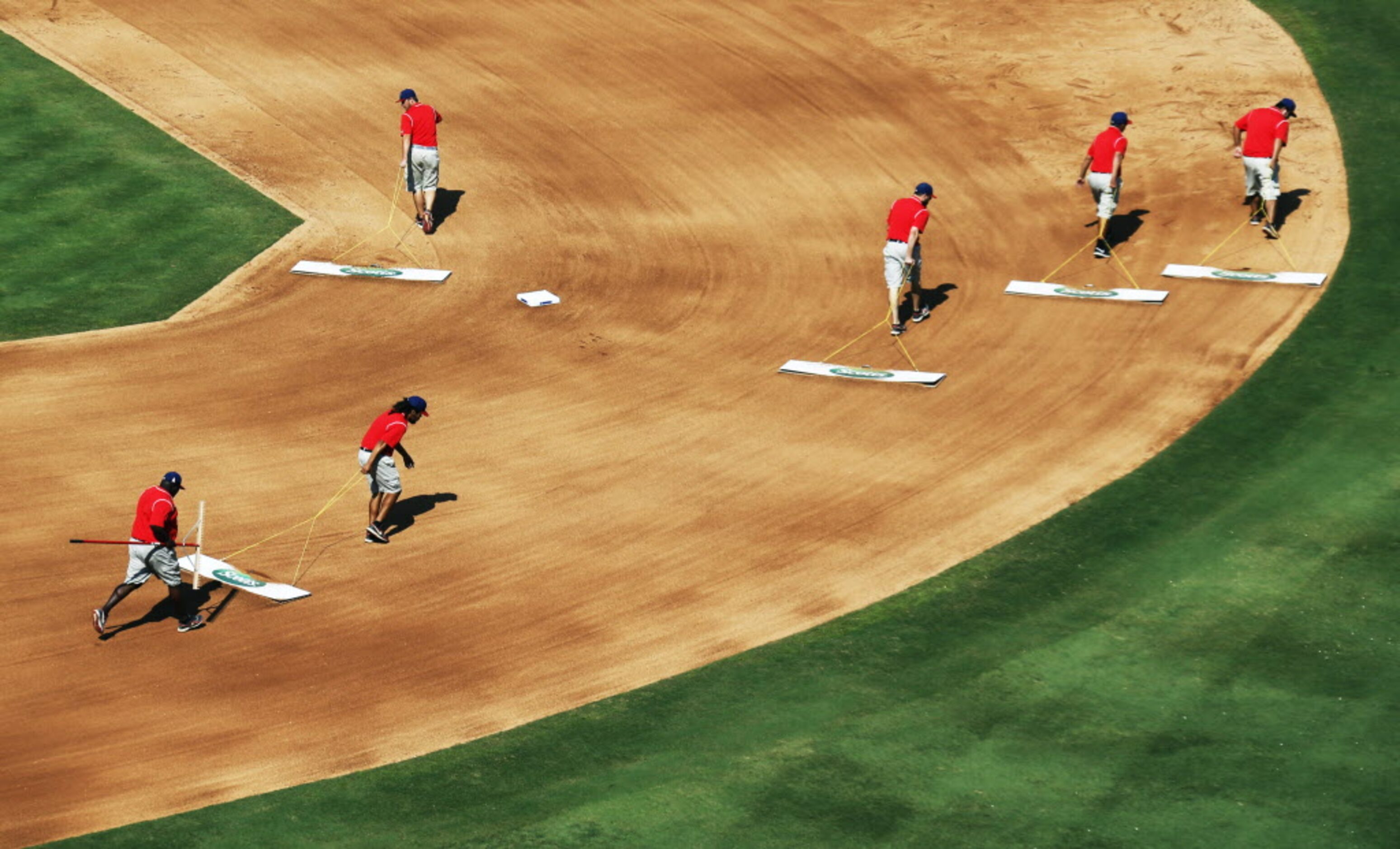 The grounds crew drags the field between innings during the Oakland Athletics vs. the Texas...