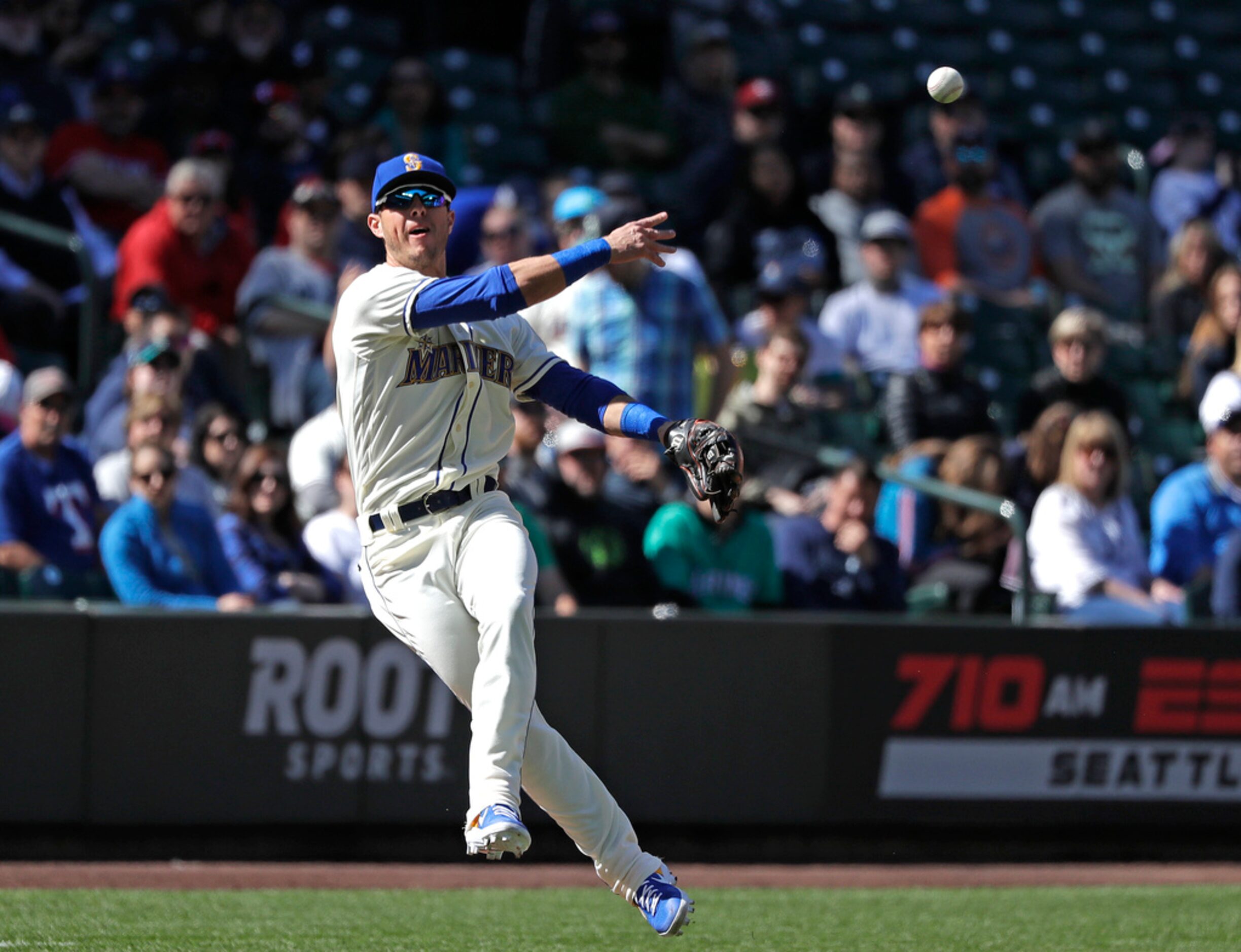 Seattle Mariners third baseman Dylan Moore throws to first for an out after fielding a...