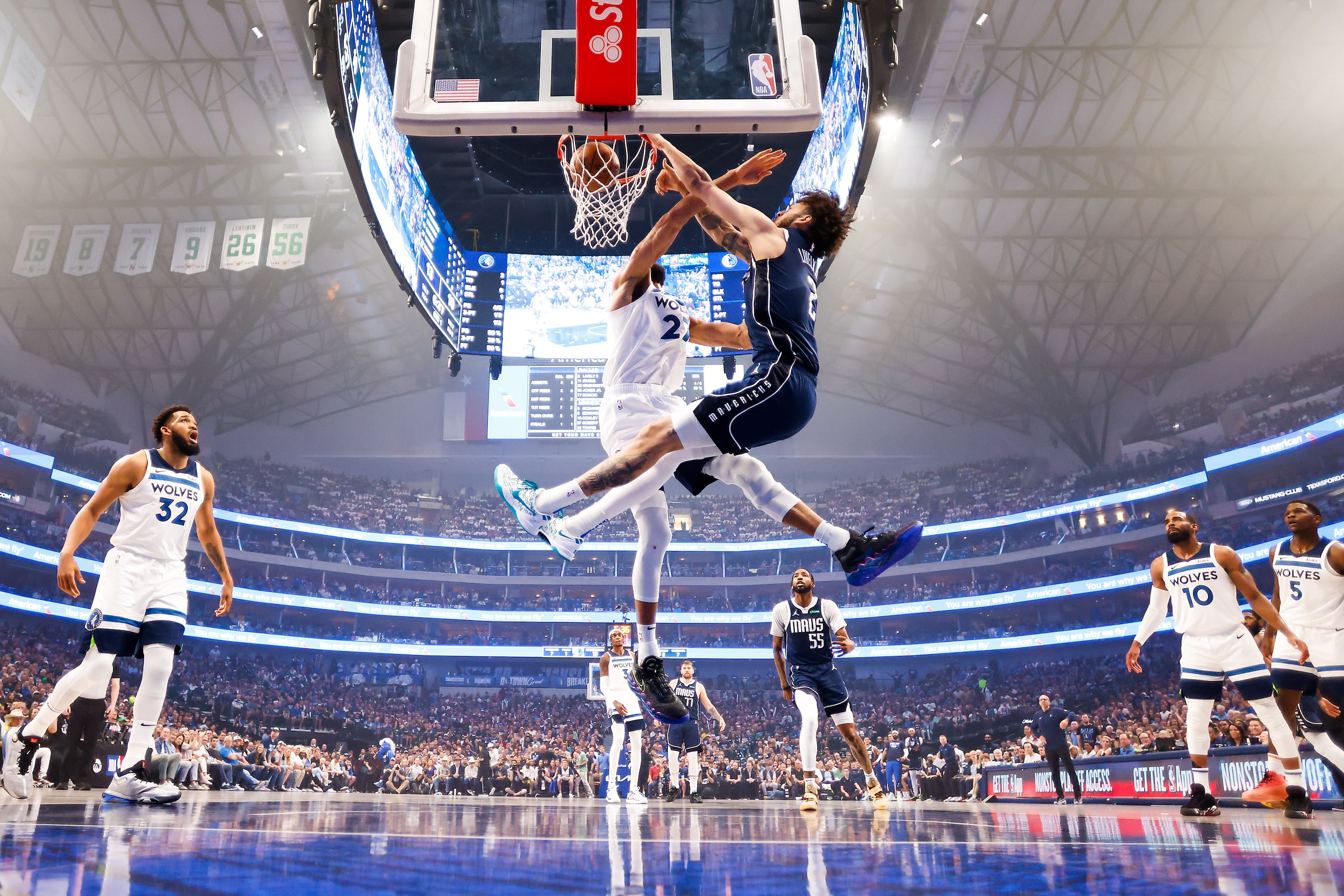 Dallas Mavericks center Dereck Lively II (2) dunks the ball past Minnesota Timberwolves...