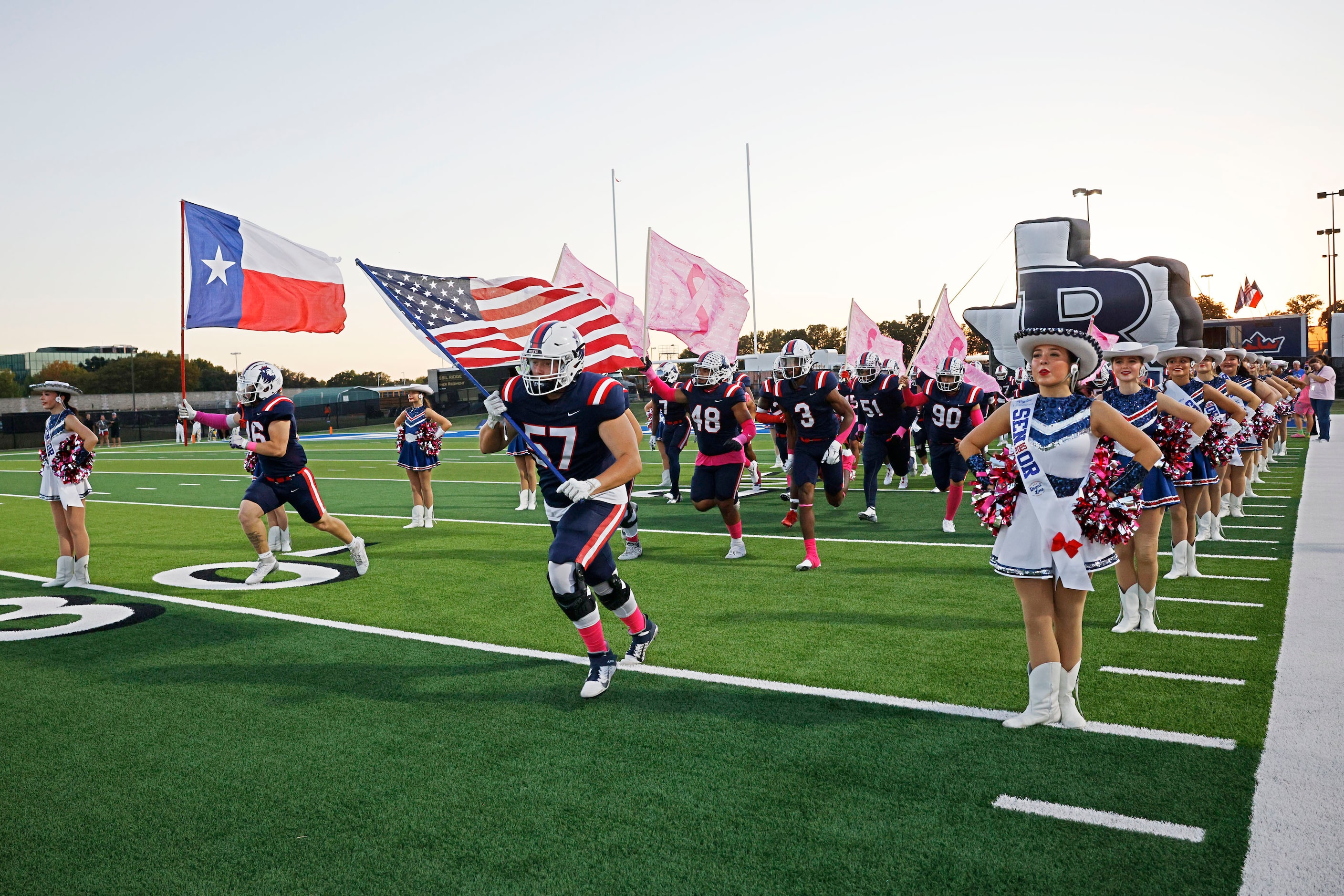 Richland players run onto the field before a high school football game against Fossil Ridge...