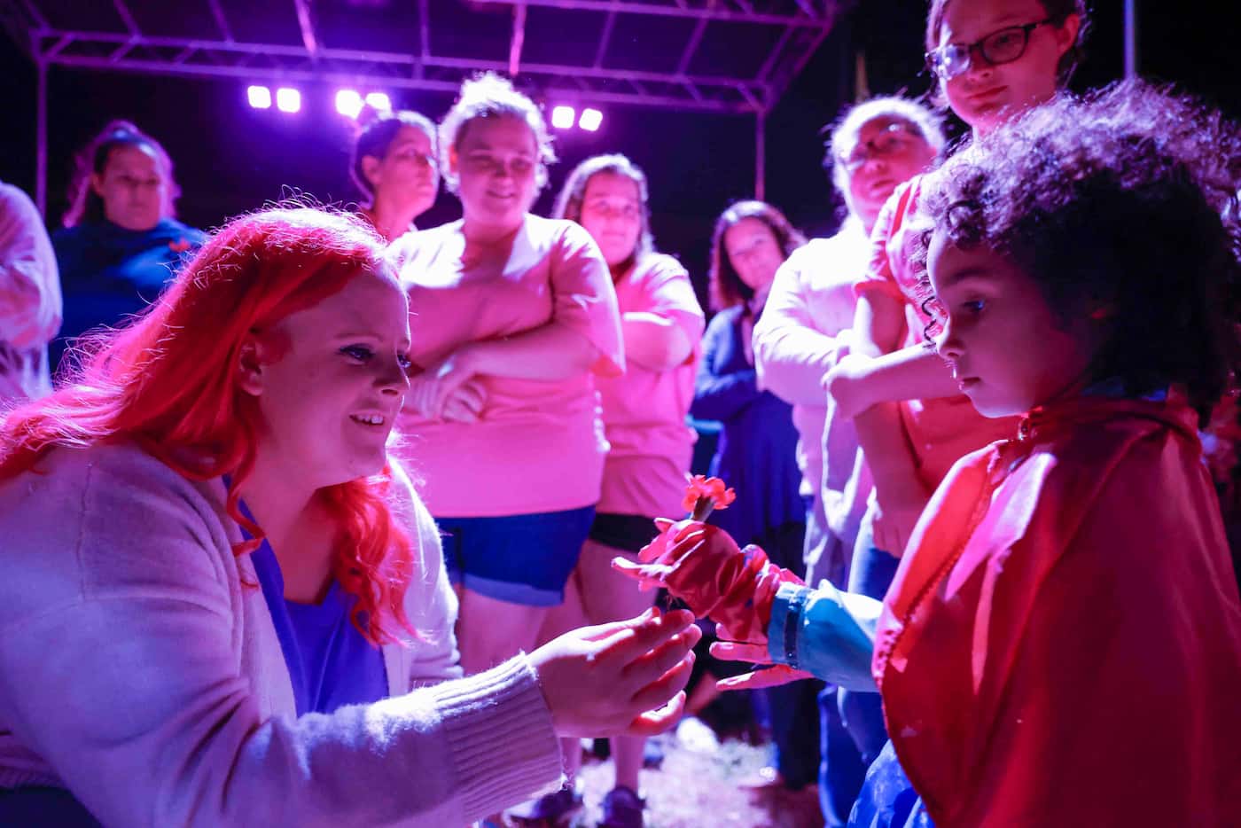 Maitlyn Presley Gandy, left, mother of late Athena Strand gives a flower to Frances Schigg,...