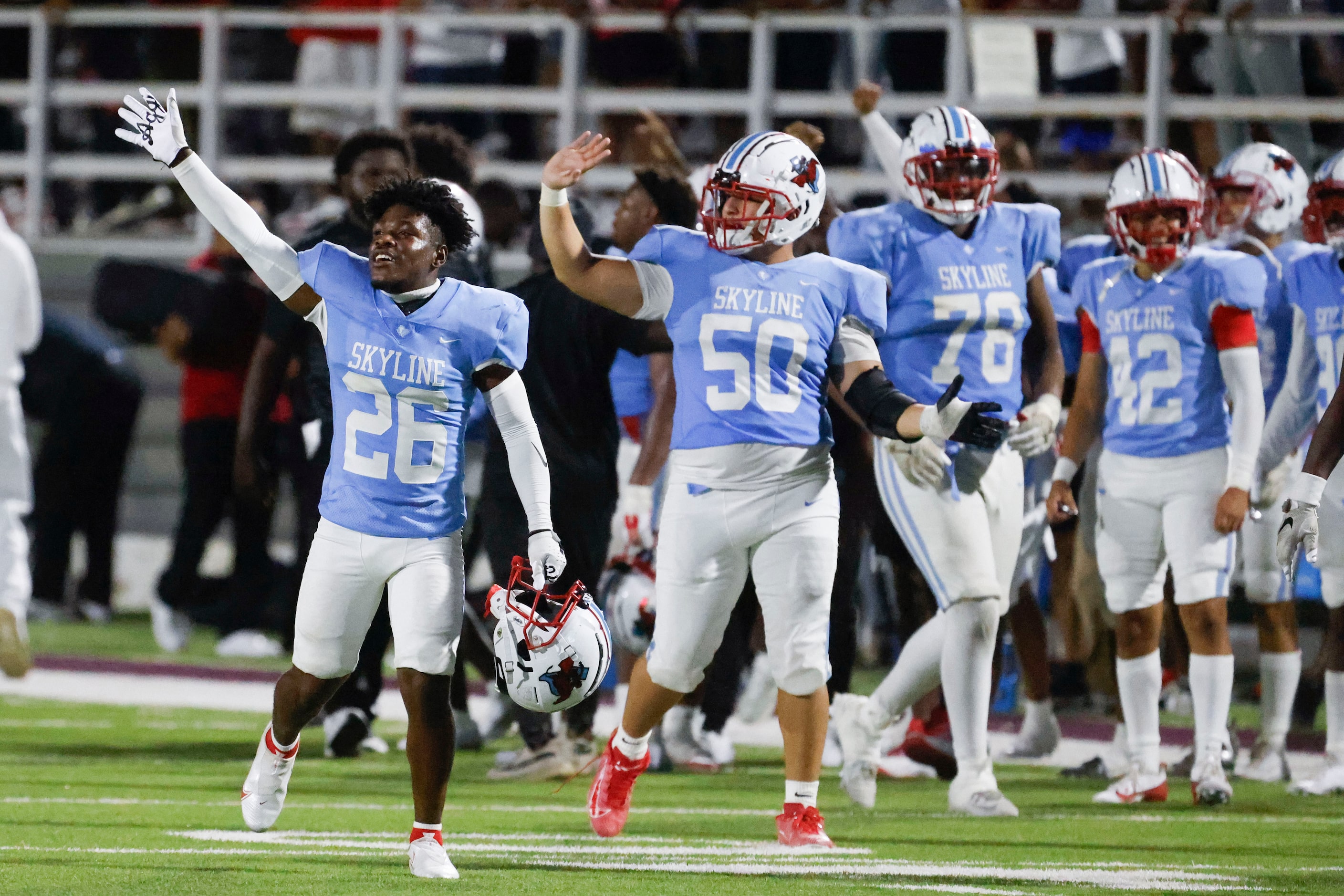 Skyline high players celebrate after winning a football game against North Forney, on...