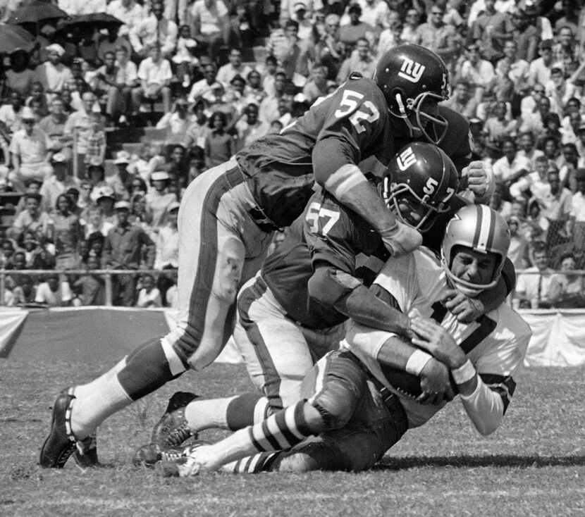 Dallas Cowboy quarterback Don Meredith (17) is tackled after an 8-yard run in the second...