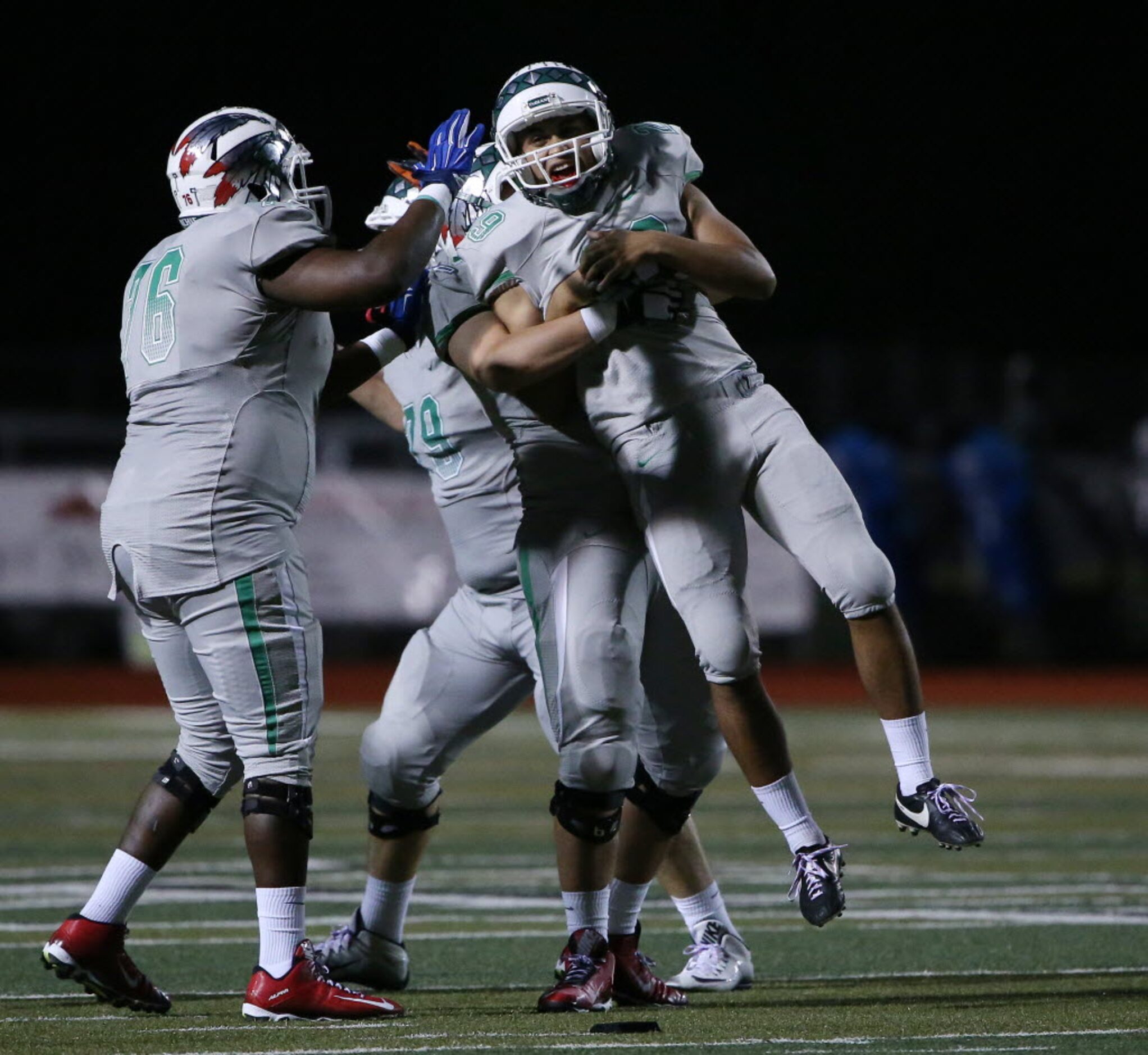 Waxahachie kicker Roberto Perez (29) is met by teammates after hitting a 46-yard field goal...