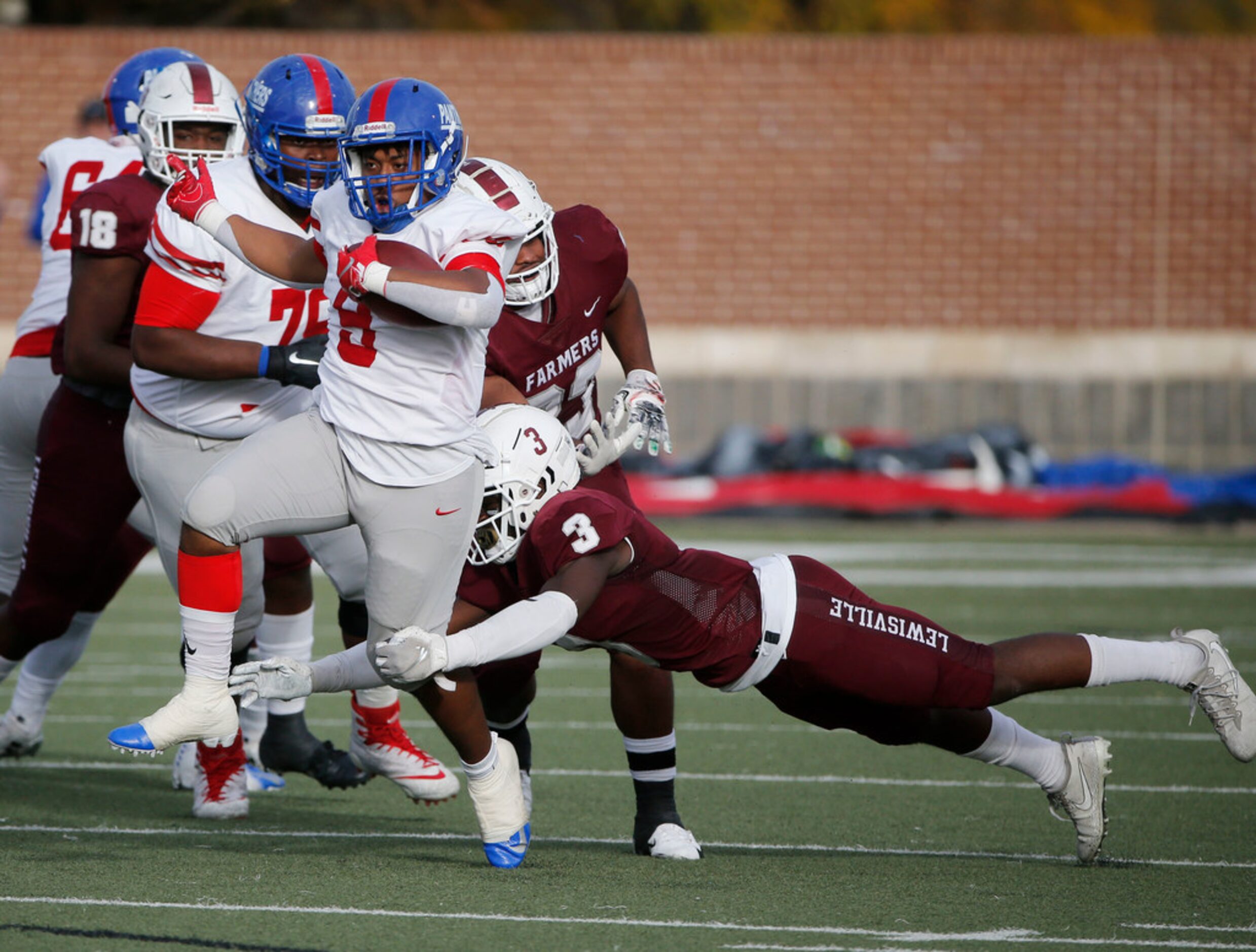 Duncanville's Trysten Smith (9) is tackled by Lewisville's Ibrahim Oyebanji (3) during the...