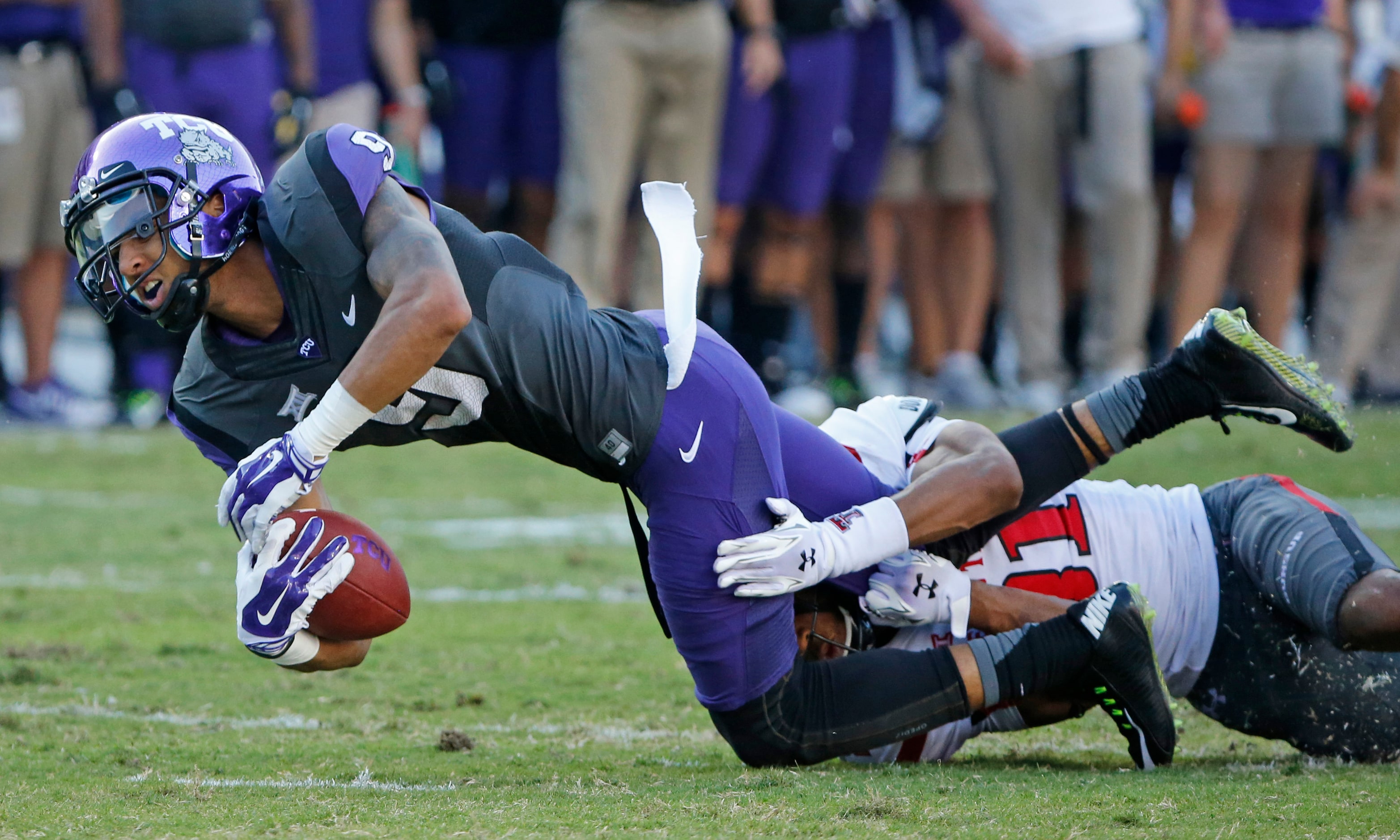 TCU receiver Josh Doctson (9) is hurt after catching a pass, as he is tackled by Texas Tech...