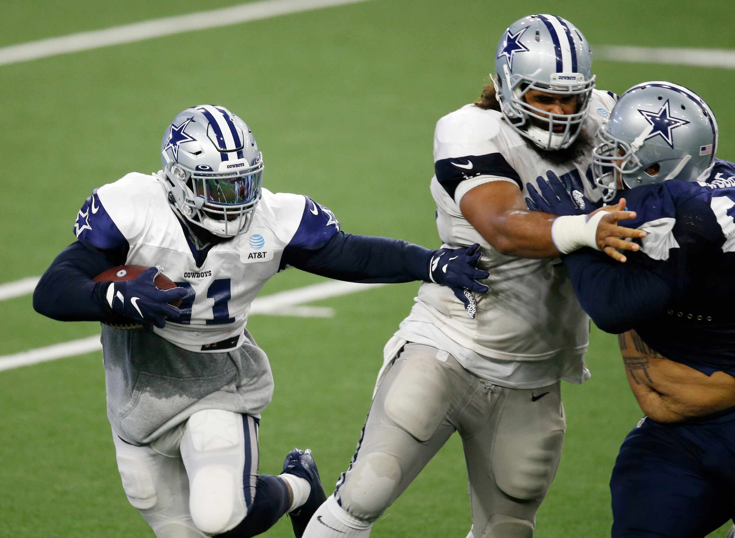 Dallas Cowboys running back Ezekiel Elliott (21) attempts to get around Dallas Cowboys...