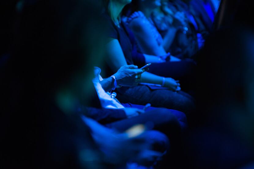 A man uses his cell phone at Twitter's "#VideoNow" event in New York.