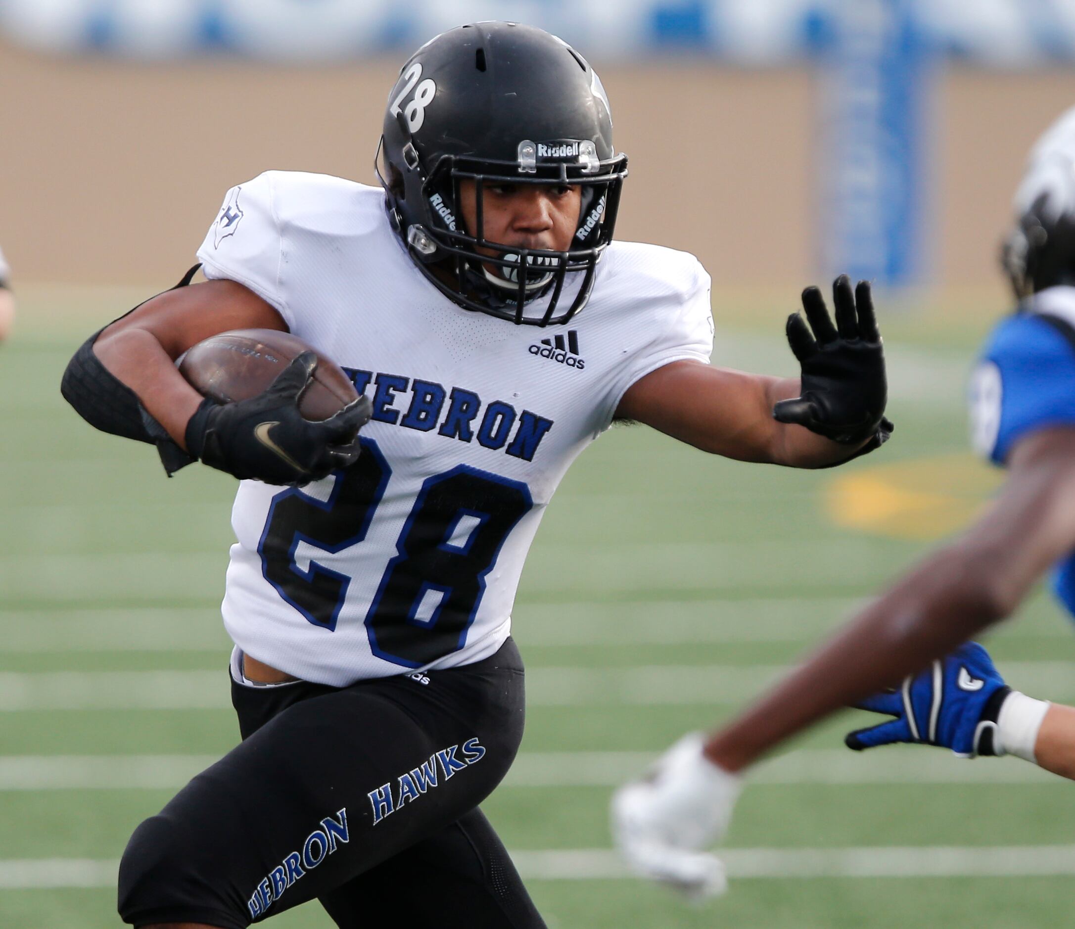 Hebron High School running back Brandon Love (28) prepares to use a stiff arm during the...