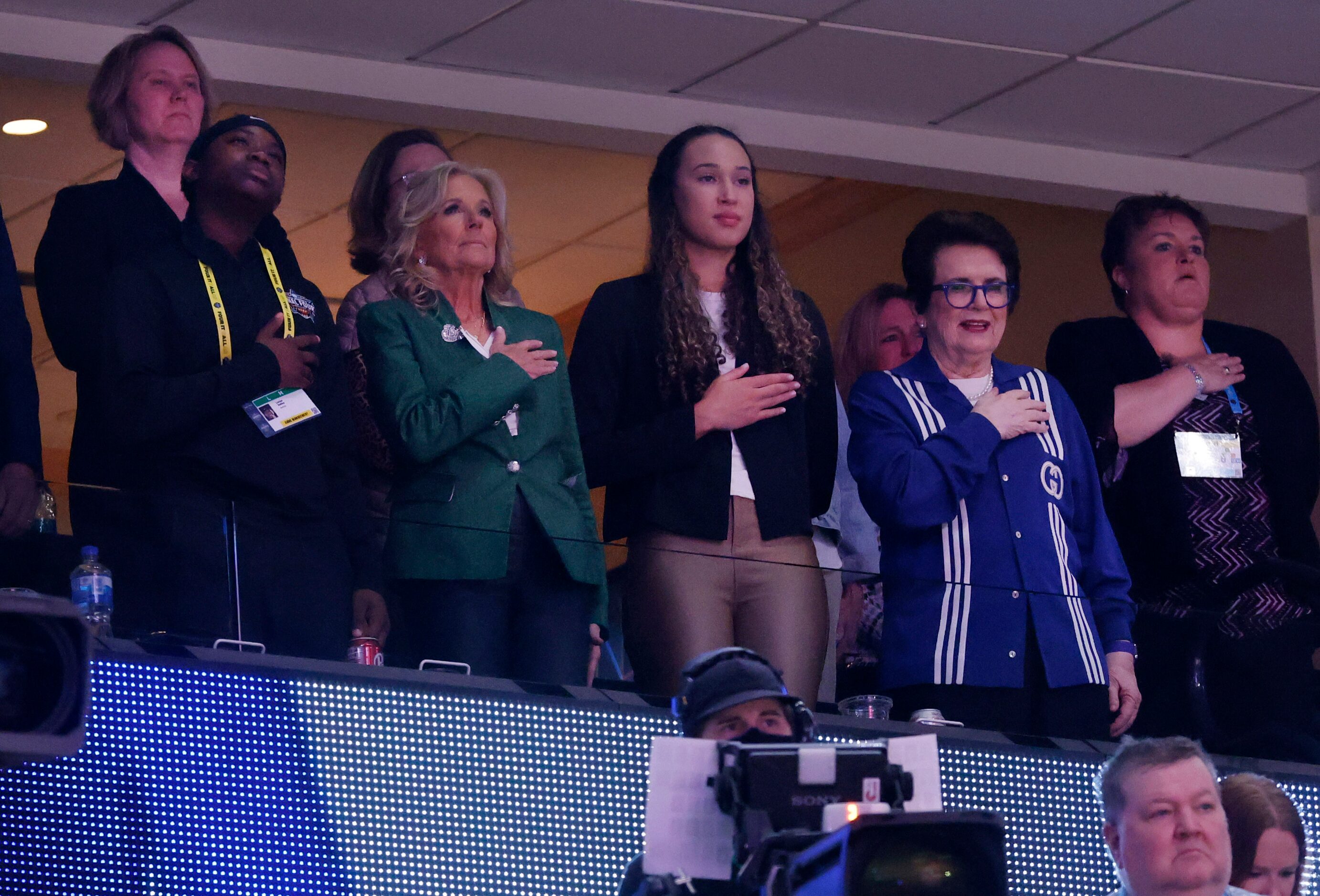 First Lady Jill Biden (center, in green jacket) stands with Bille Jean King and other...