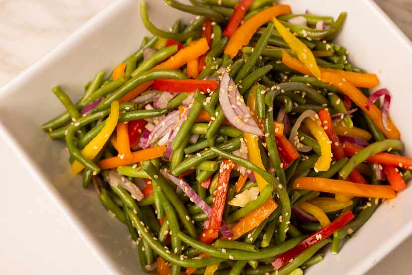 Dress your green beans with garlic sauce and rainbow peppers.
