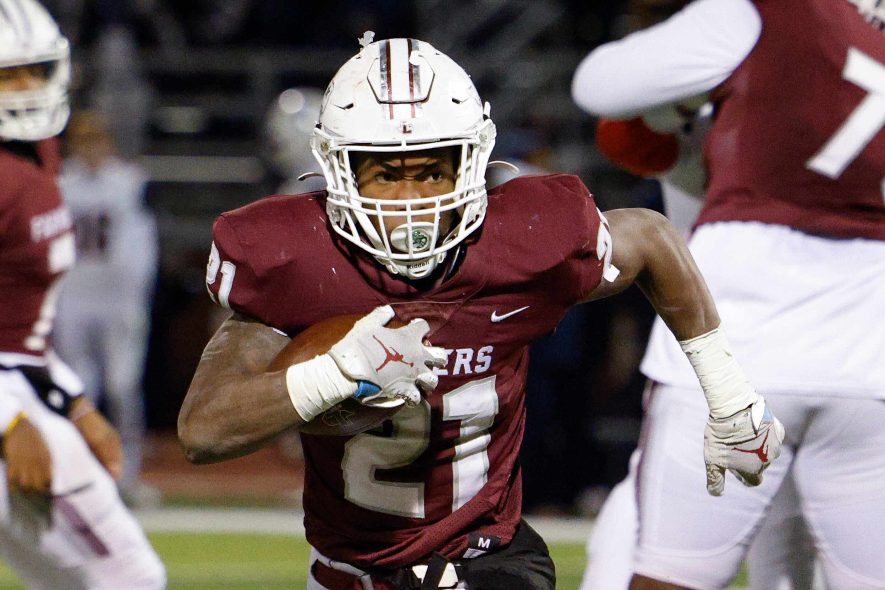 Lewisville running back Viron Ellison (21) runs up the field during the second half of a...