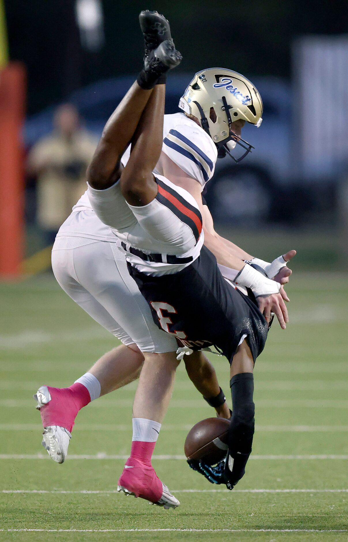 Lake Highlands High wide receiver De' De’anthony Flagge (3) is tackled by Jesuit Dallas...