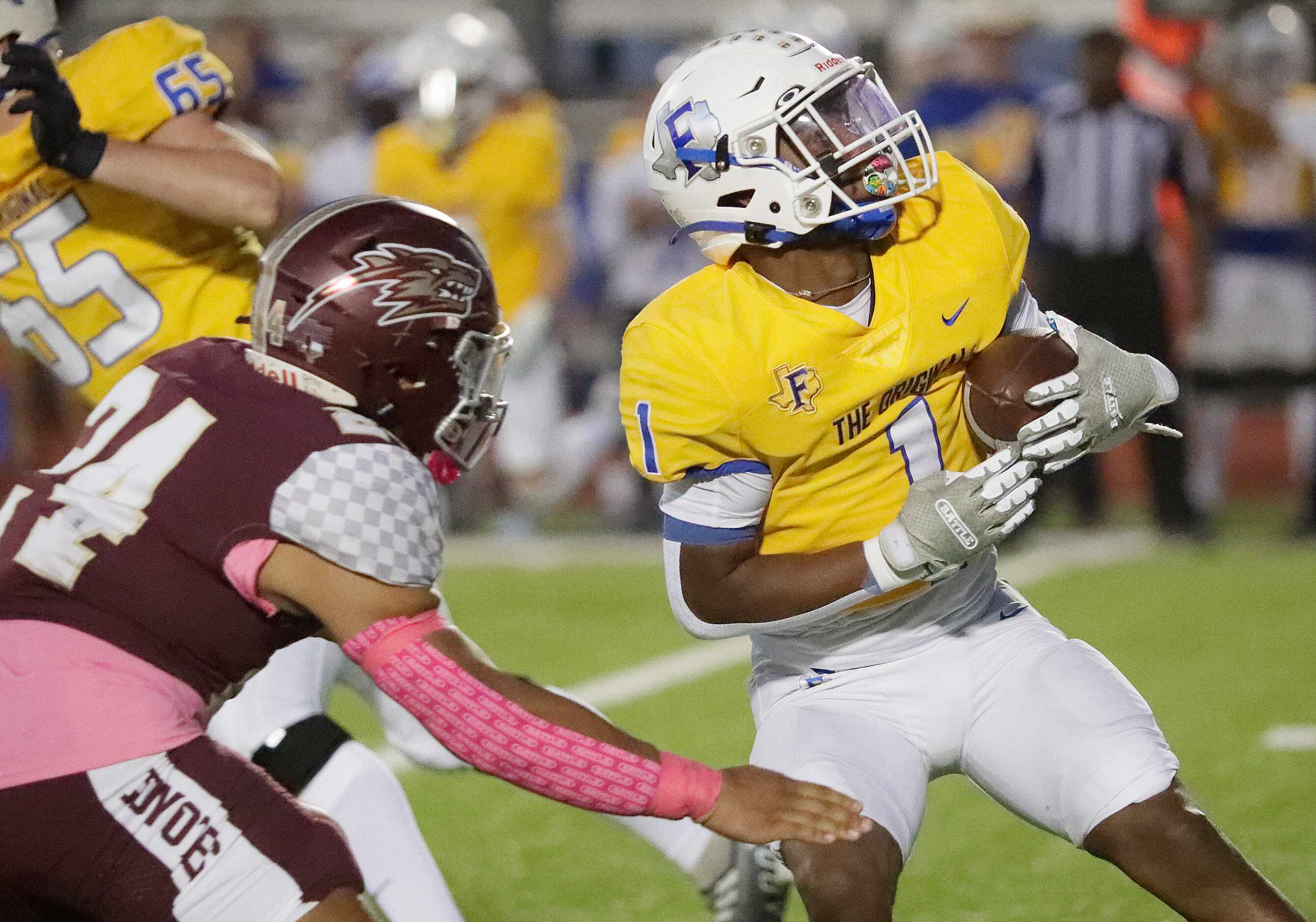 Frisco High School running back Kam Pendergraph (1) puts a spin move on Frisco Heritage High...