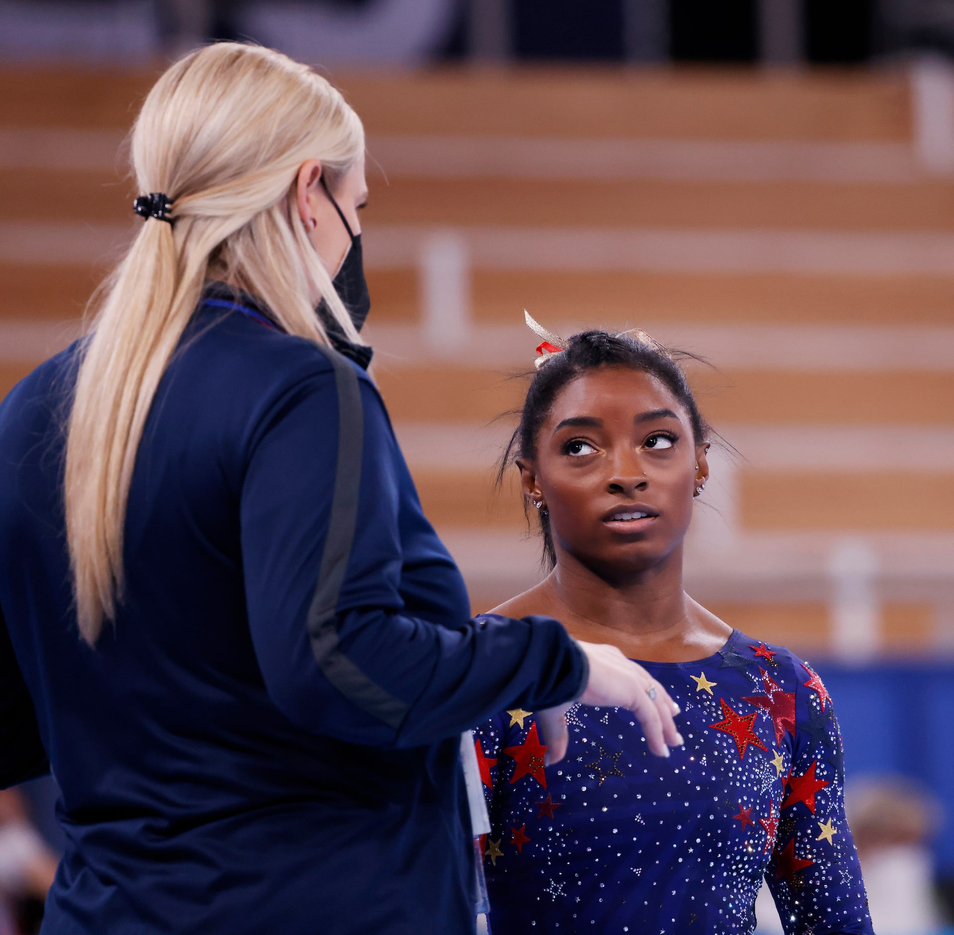 USA’s Simone Biles gets instruction from her coach Cecile Landi before competing in a...