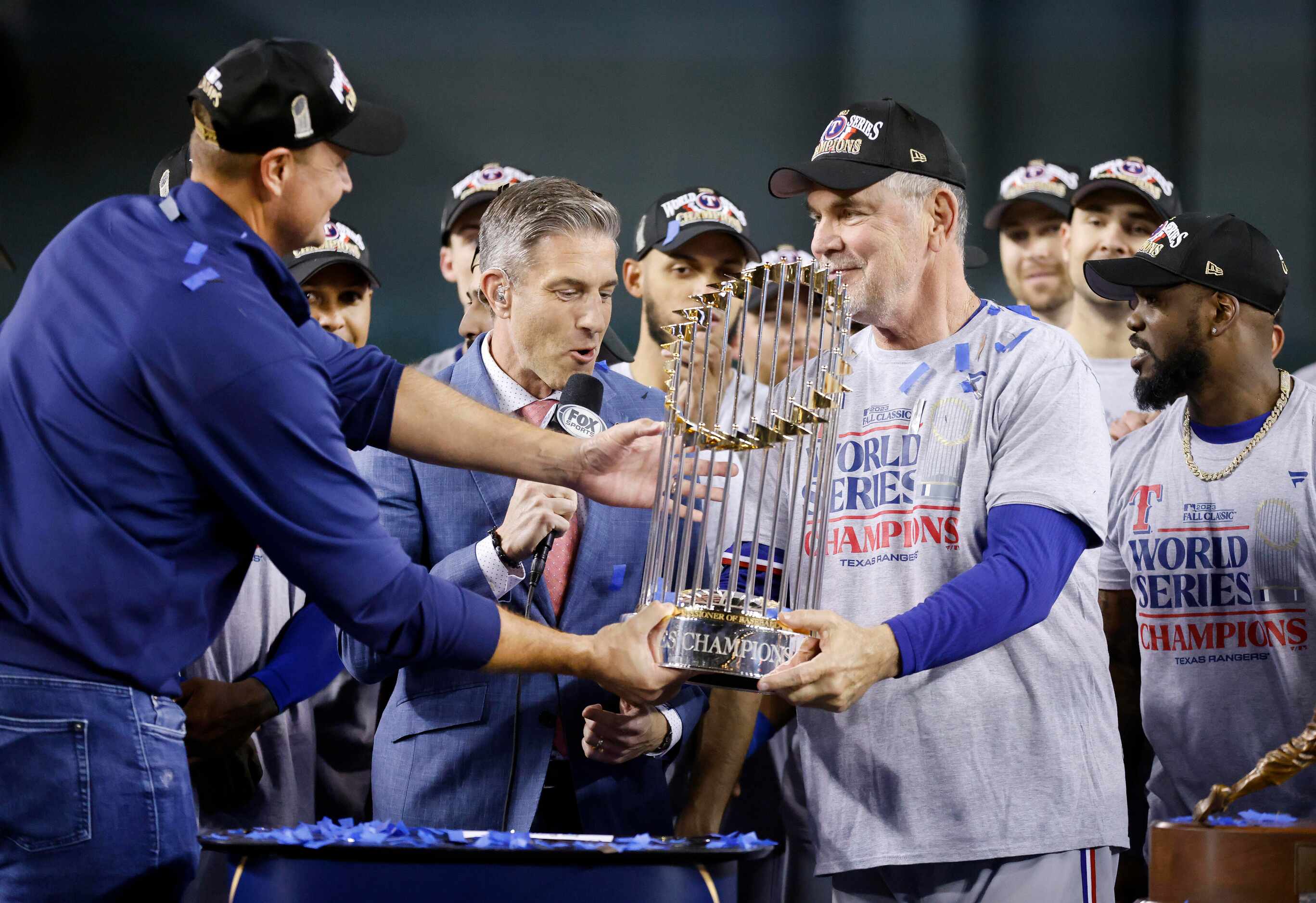 Texas Rangers general manager Chris Young (left) hands manager Bruce Bochy the World Series...
