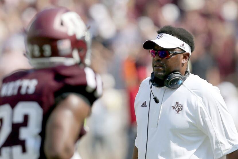 Texas A&M head coach Kevin Sumlin talks to his players as they come off the field during the...