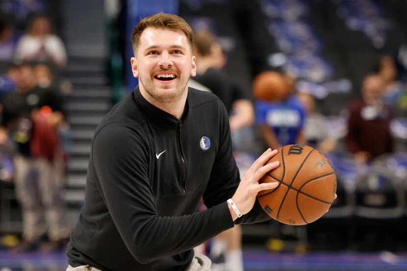 Dallas Mavericks guard Luka Doncic (77) warms up before an NBA basketball game against the...