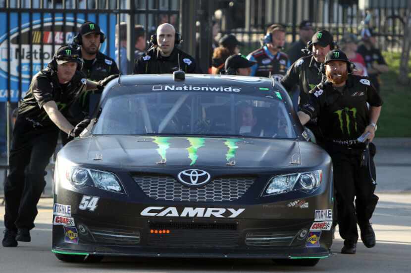 Nationwide Series driver Kyle Busch (54) gets some help from his crew to get to the garage...