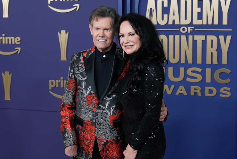 Randy Travis, left, and Mary Davis arrive at the 59th annual Academy of Country Music Awards...