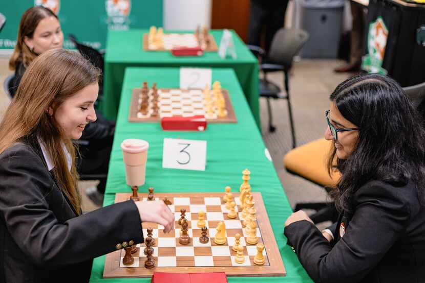 Two students engage in a game of chess.