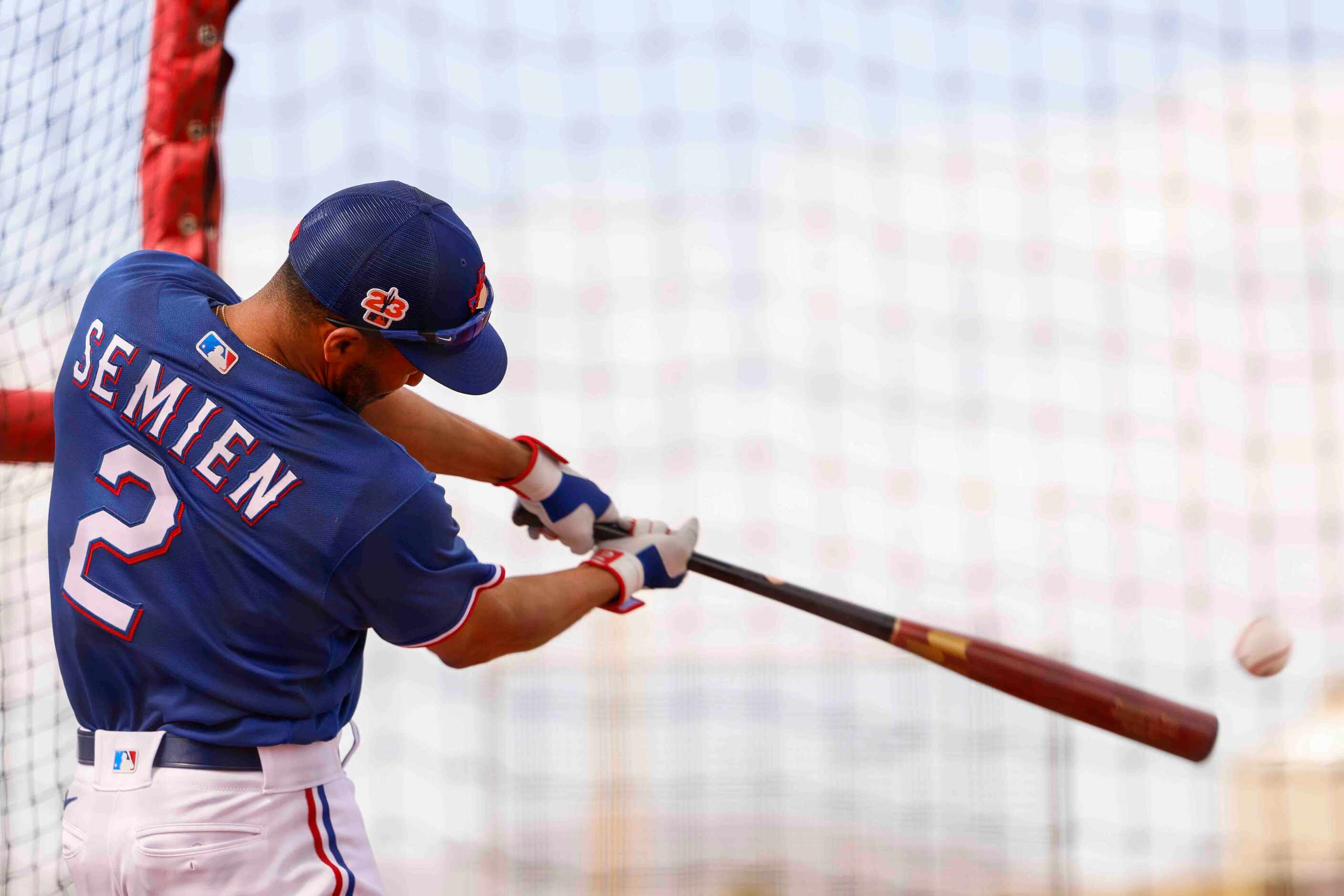 Texas Rangers infielder Marcus Semien hits a ball during batting practice at spring training...