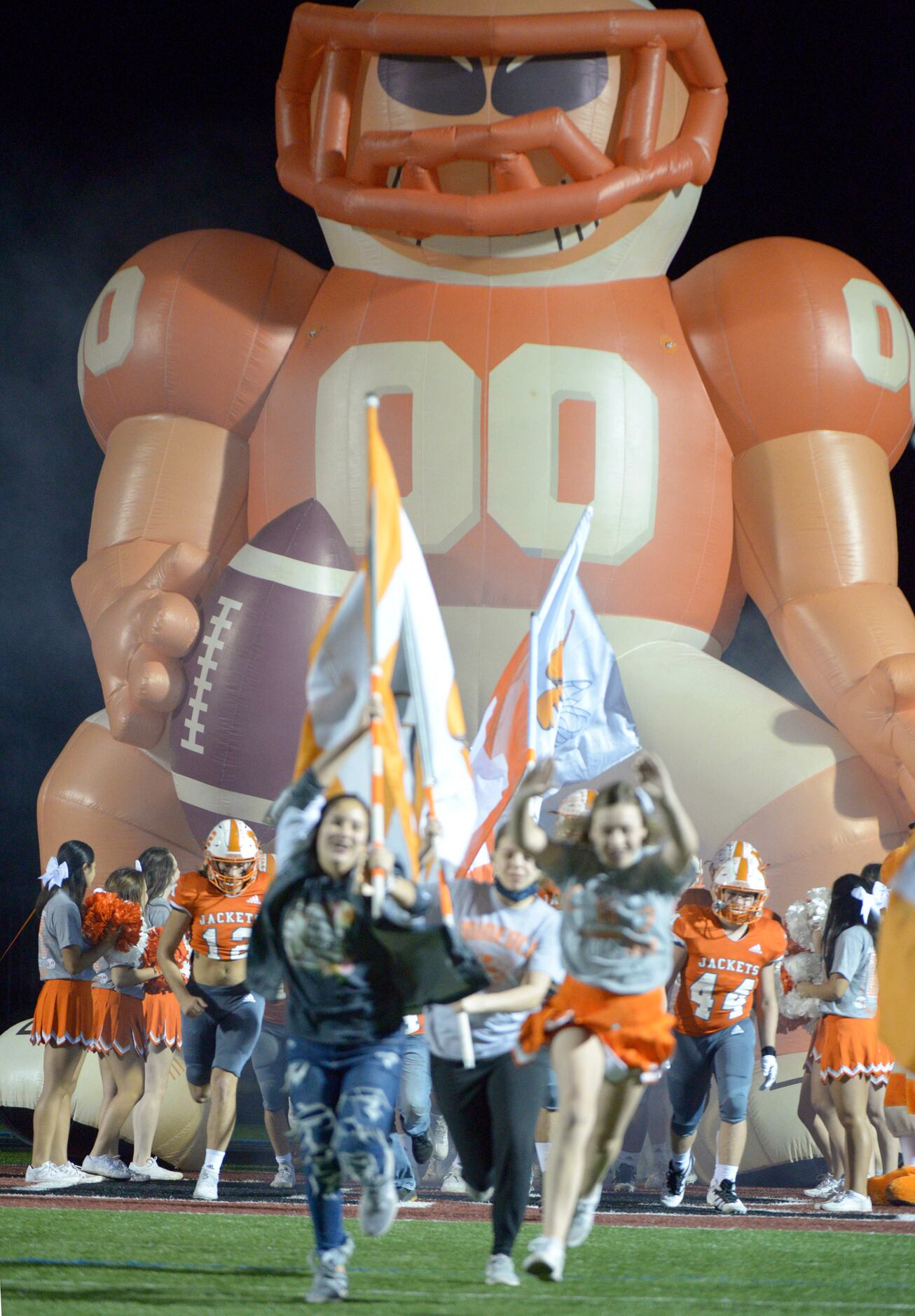 Mineola players run onto the field before a Class 3A Division I area-round playoff game...