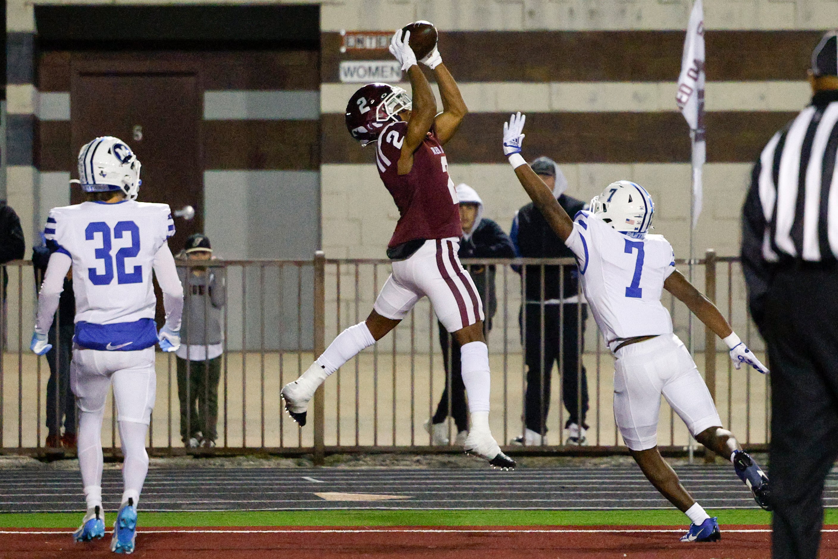 Red Oak wide receiver Brayden Robinson (2) makes a leaping catch over Midlothian defensive...