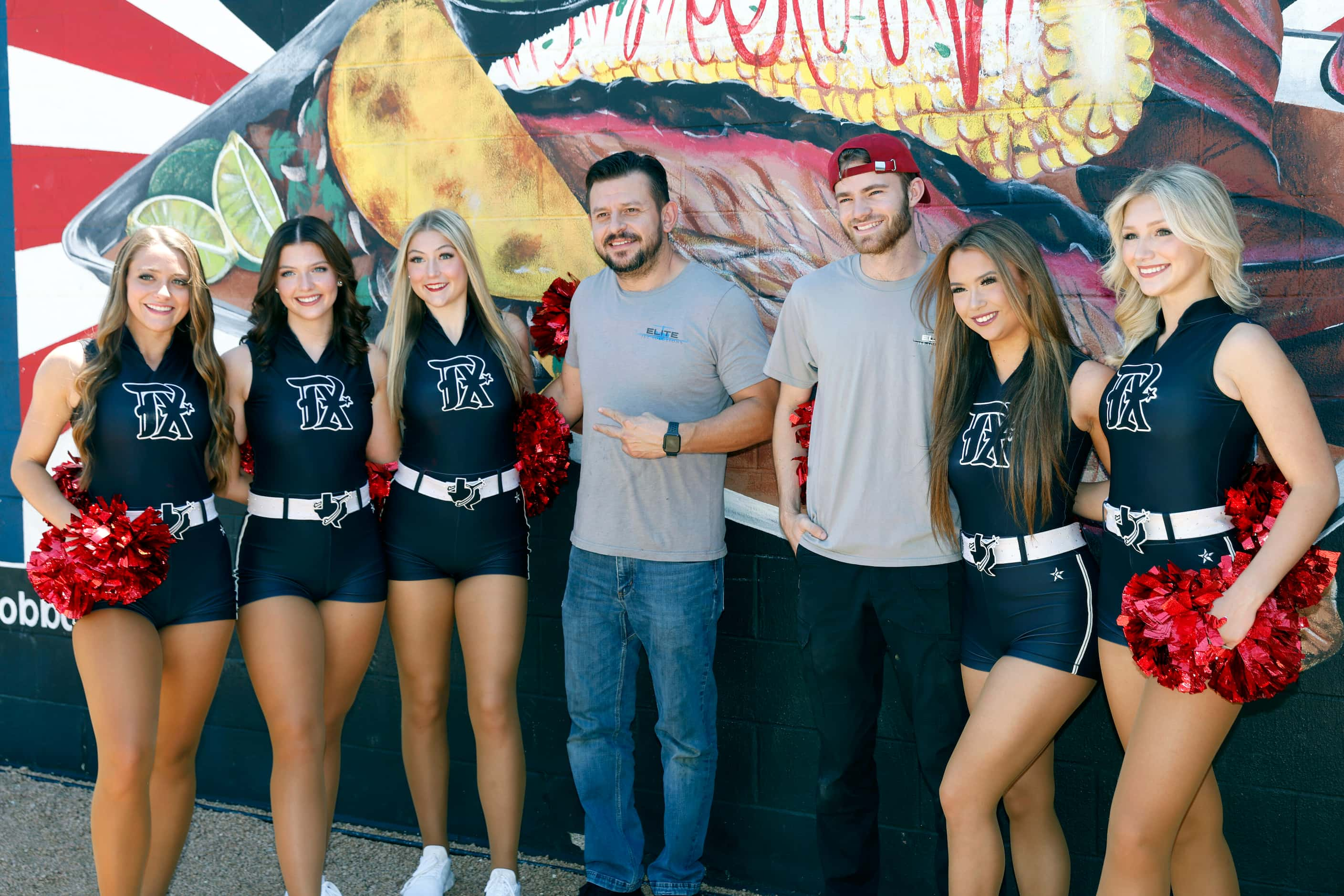 Angel Rivera (center left) and Jacob Bedow pose for a photo with members of the Texas...