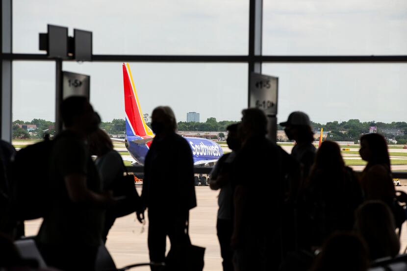 Passengers board a flight to New Orleans at Dallas Love Field in Dallas on May 19.