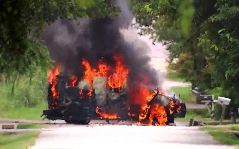 An armored vehicle driven by James Boulware caught fire as police blew up two pipe bombs...