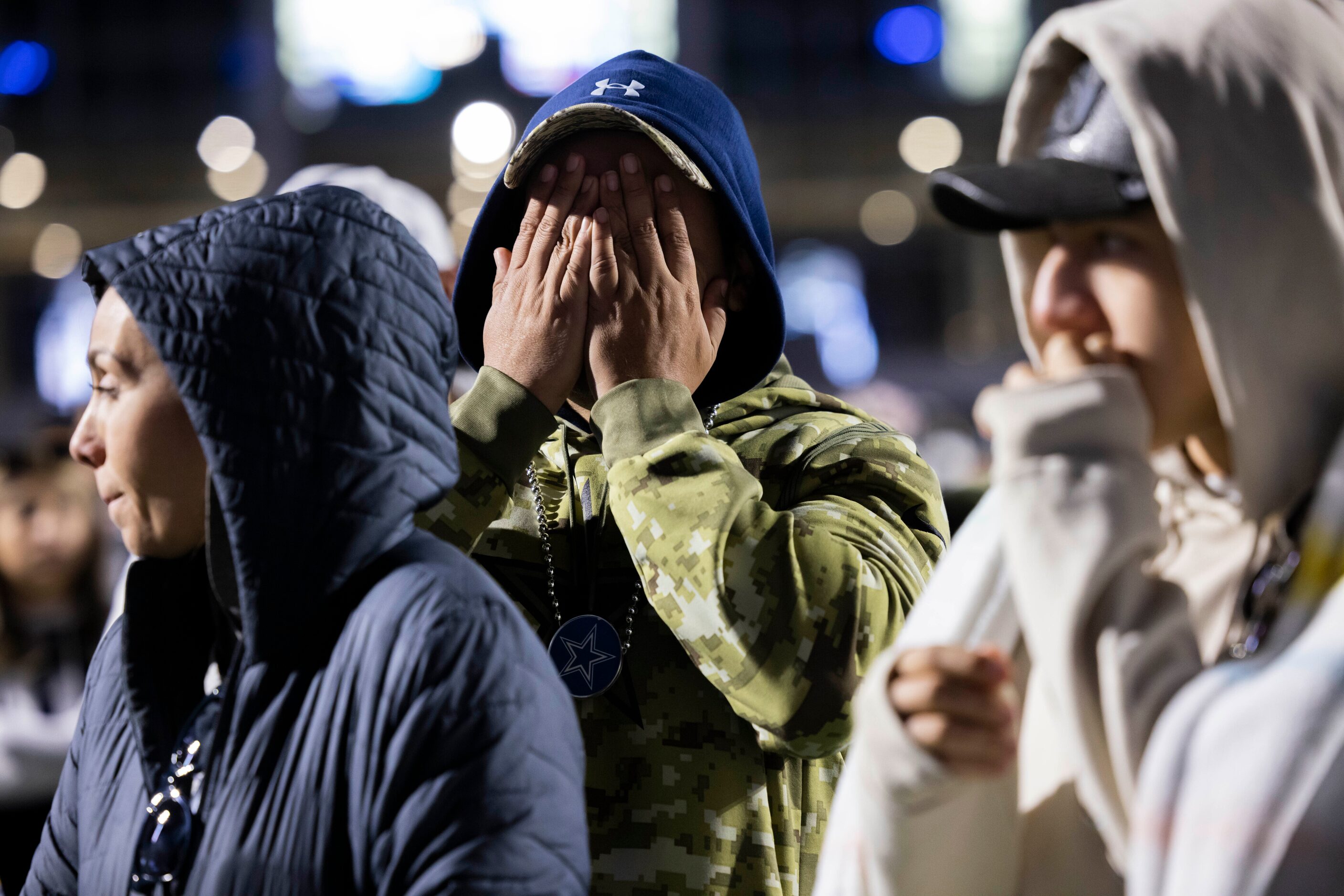 A Dallas Cowboys fan covers his face as the Cowboys fail to catch up to the San Francisco...