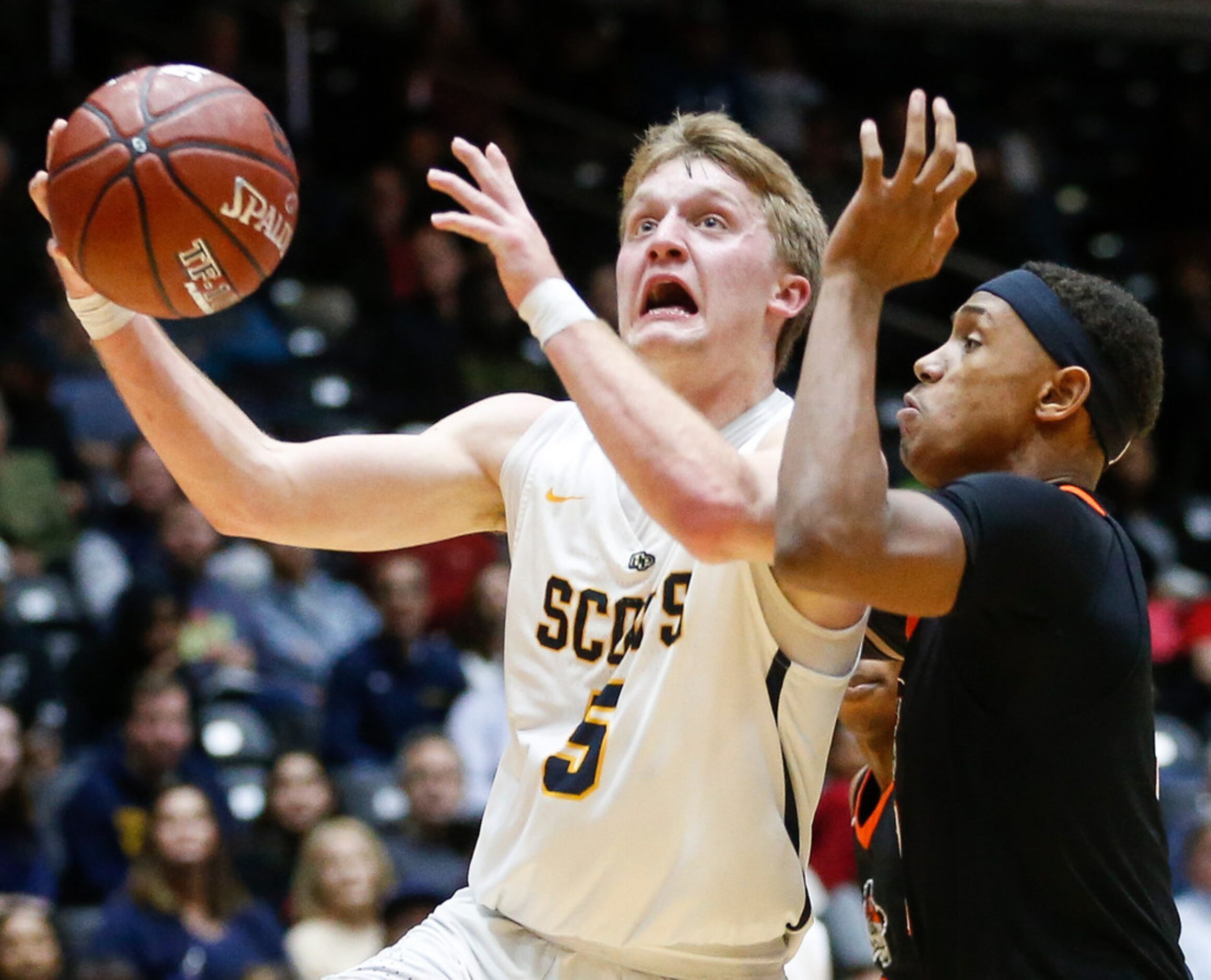 Highland Park's Drew Scott drives to the basket past Lancaster's Markeis Sykes (3) during...