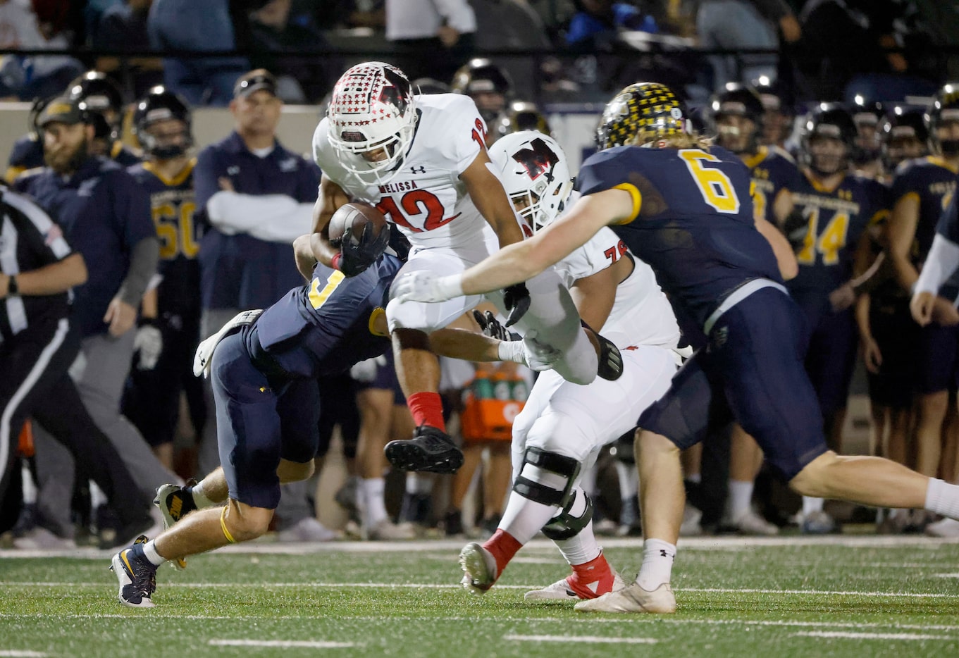 Melissa’s Ashton Mitchell-Johnson runs fro yardage as he is tackled by Stephenviles’ Kyler...