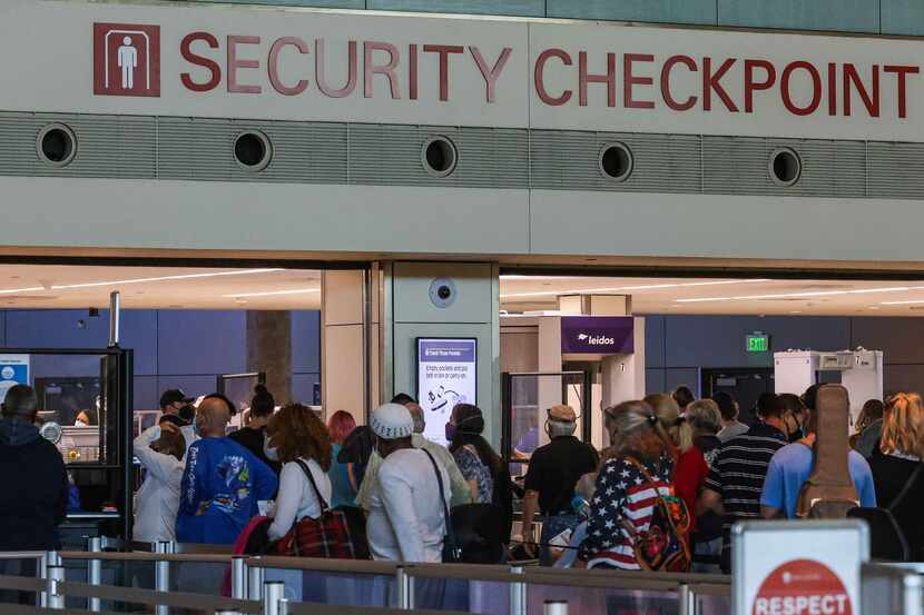 Travelers go through a crowded security checkpoint at the Dallas Love Field airport in...