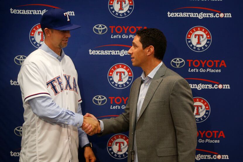 Newly signed Texas Rangers pitcher Mike Minor shakes hands with Texas Rangers General...