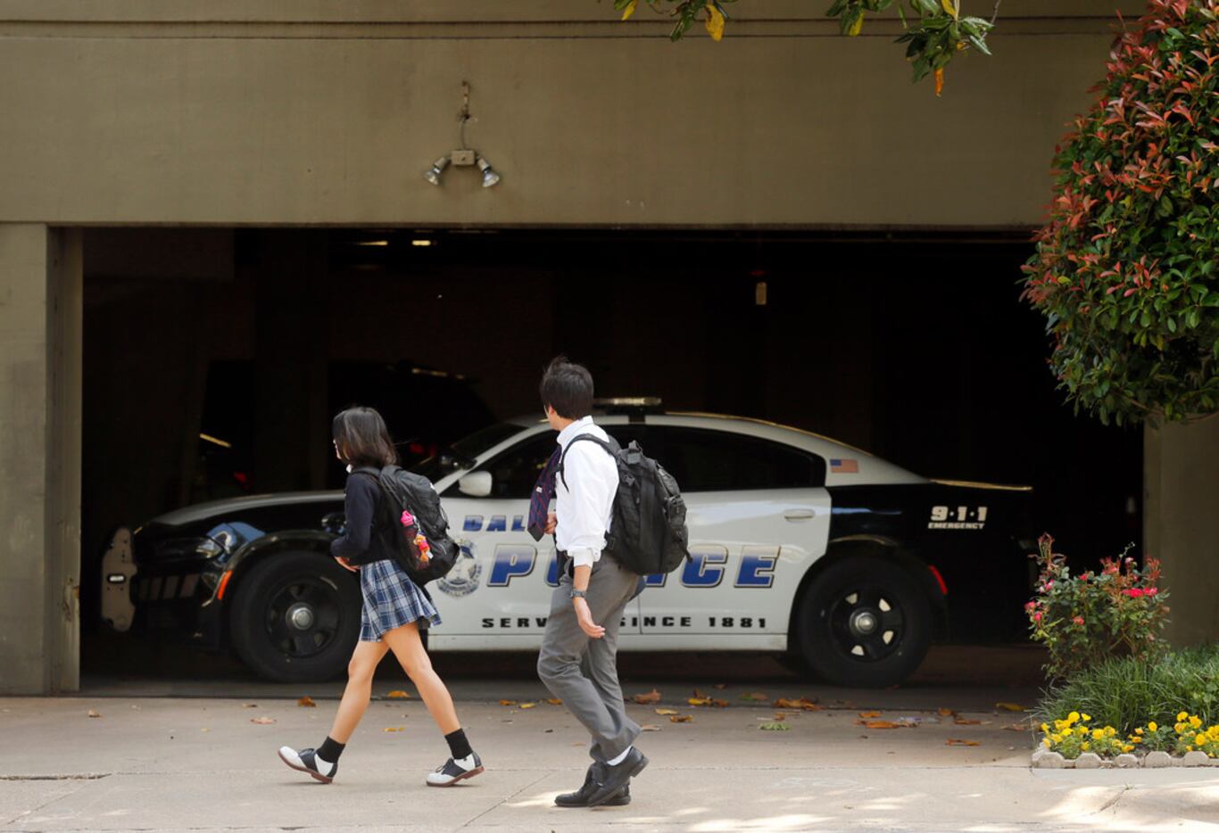 Students walking home from school Wednesday passed by a Dallas police in font of the...