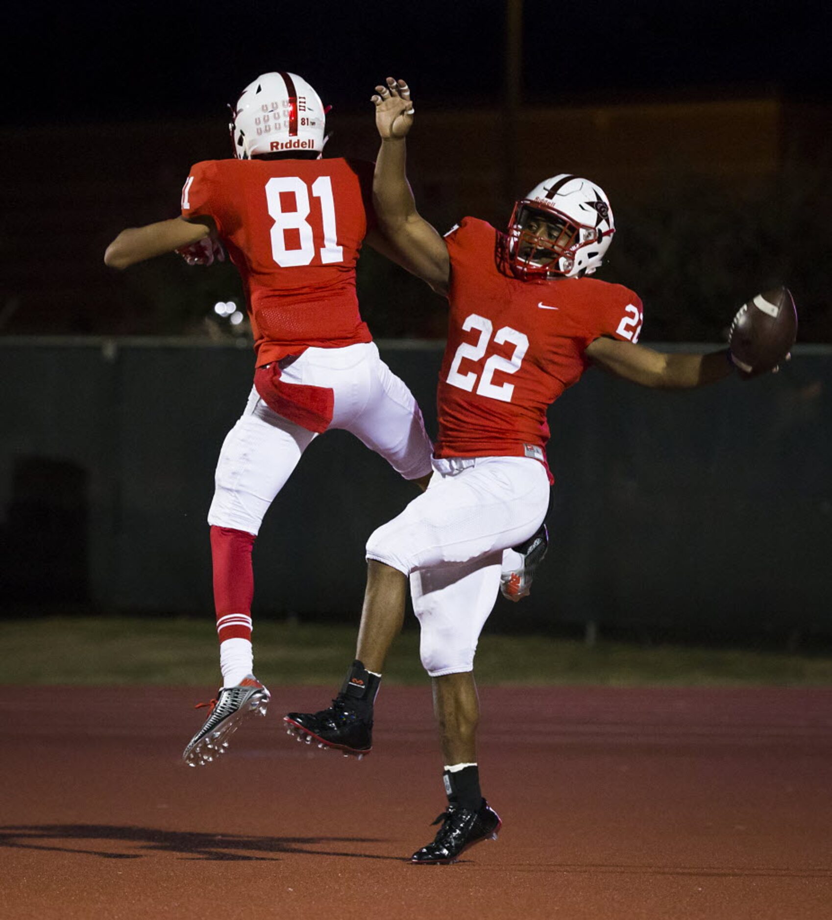 Coppell running back Brandon Rice (22) celebrates with teammate Jarel McGill (81) after...