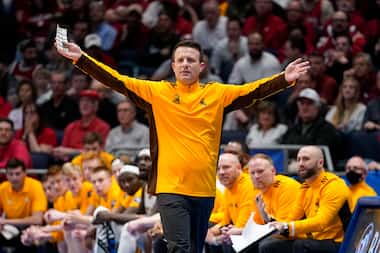 Wyoming head coach Jeff Linder, center, reacts during the first half of a First Four game...