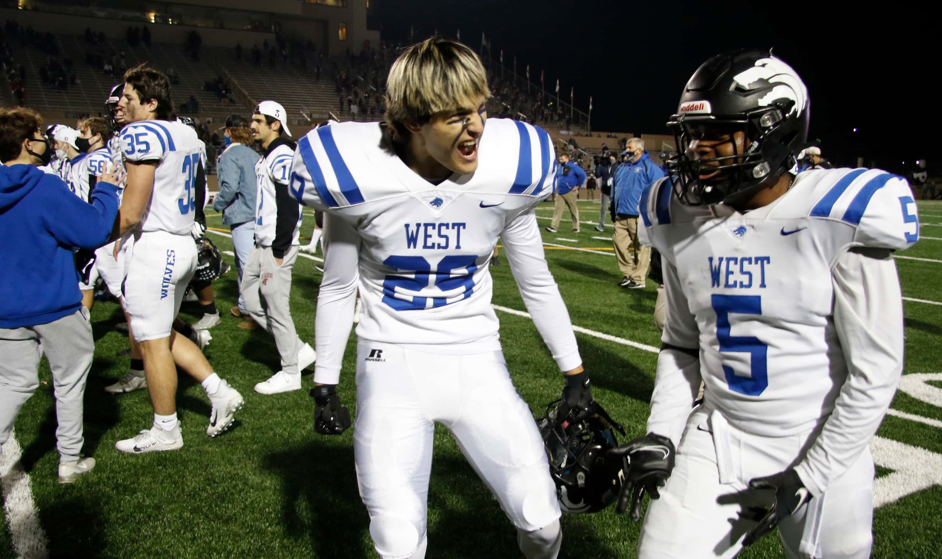 Plano West Wolves Colin Dime (29) and Aaron Jones (5) revel in the moment at midfield...