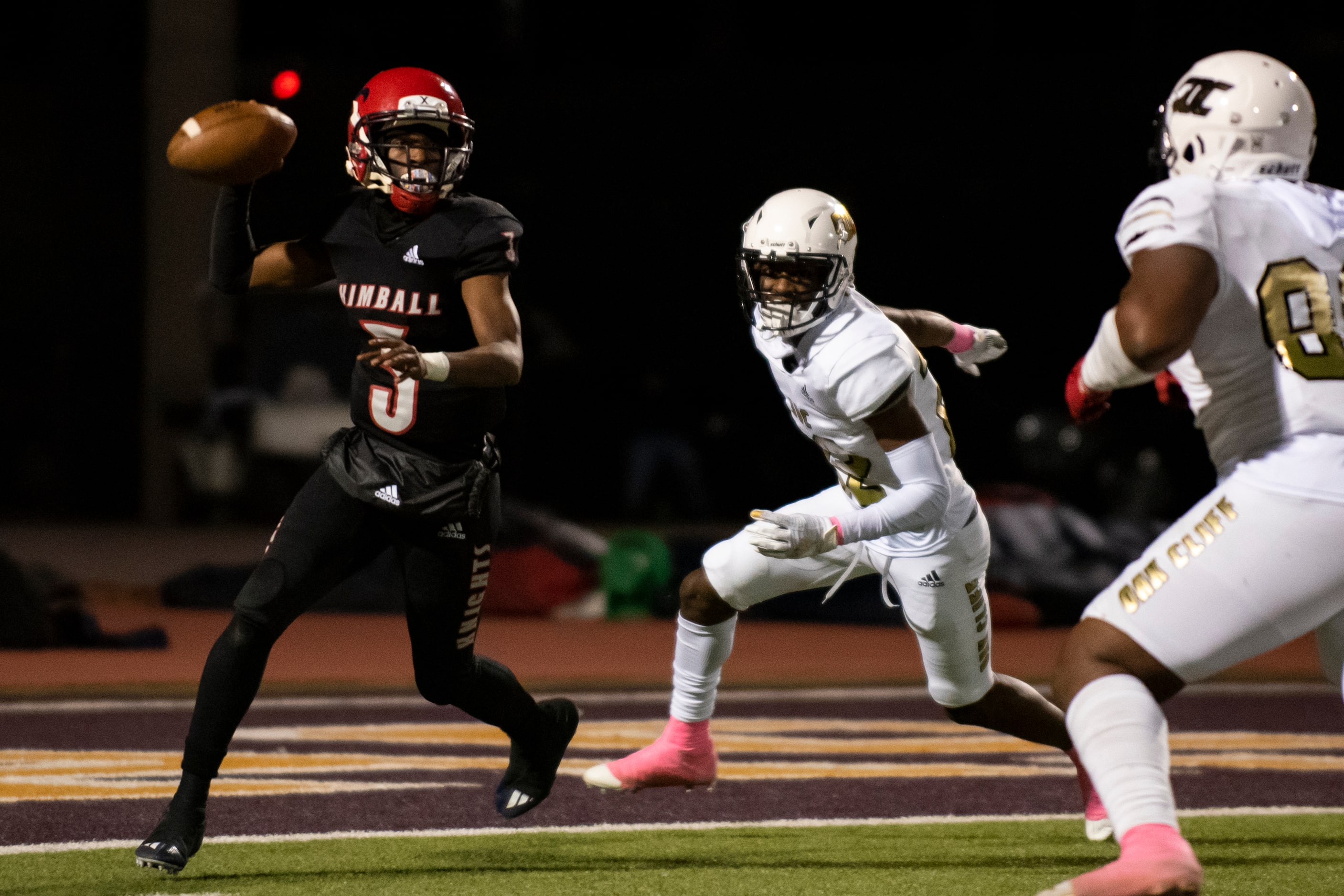 Kimball senior Jerqualan Parks (3) evades South Oak Cliff junior Jamarion Clark (22) during...