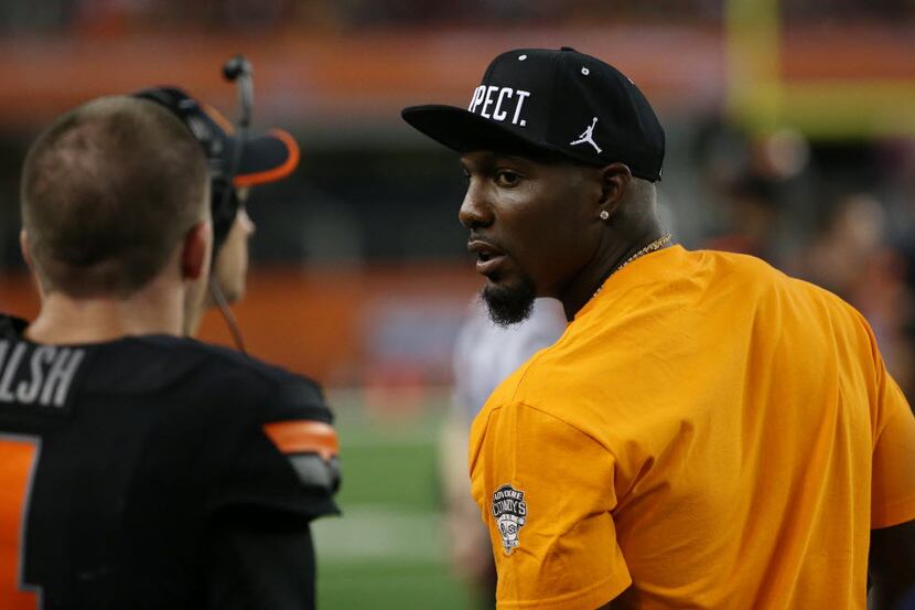 Dallas Cowboys wide receiver Dez Bryant looks over at Oklahoma State quarterback J.W. Walsh...