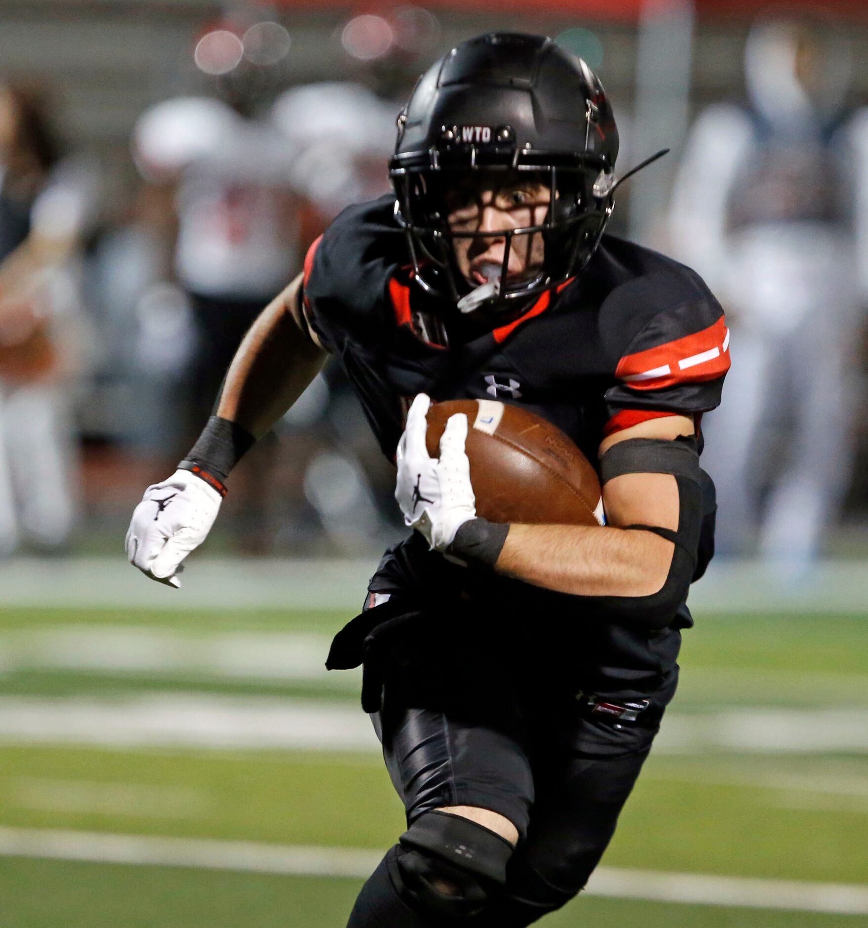 Rockwall Heath QB Jack Devenport (17) heads for a touchdown during the first half of a high...