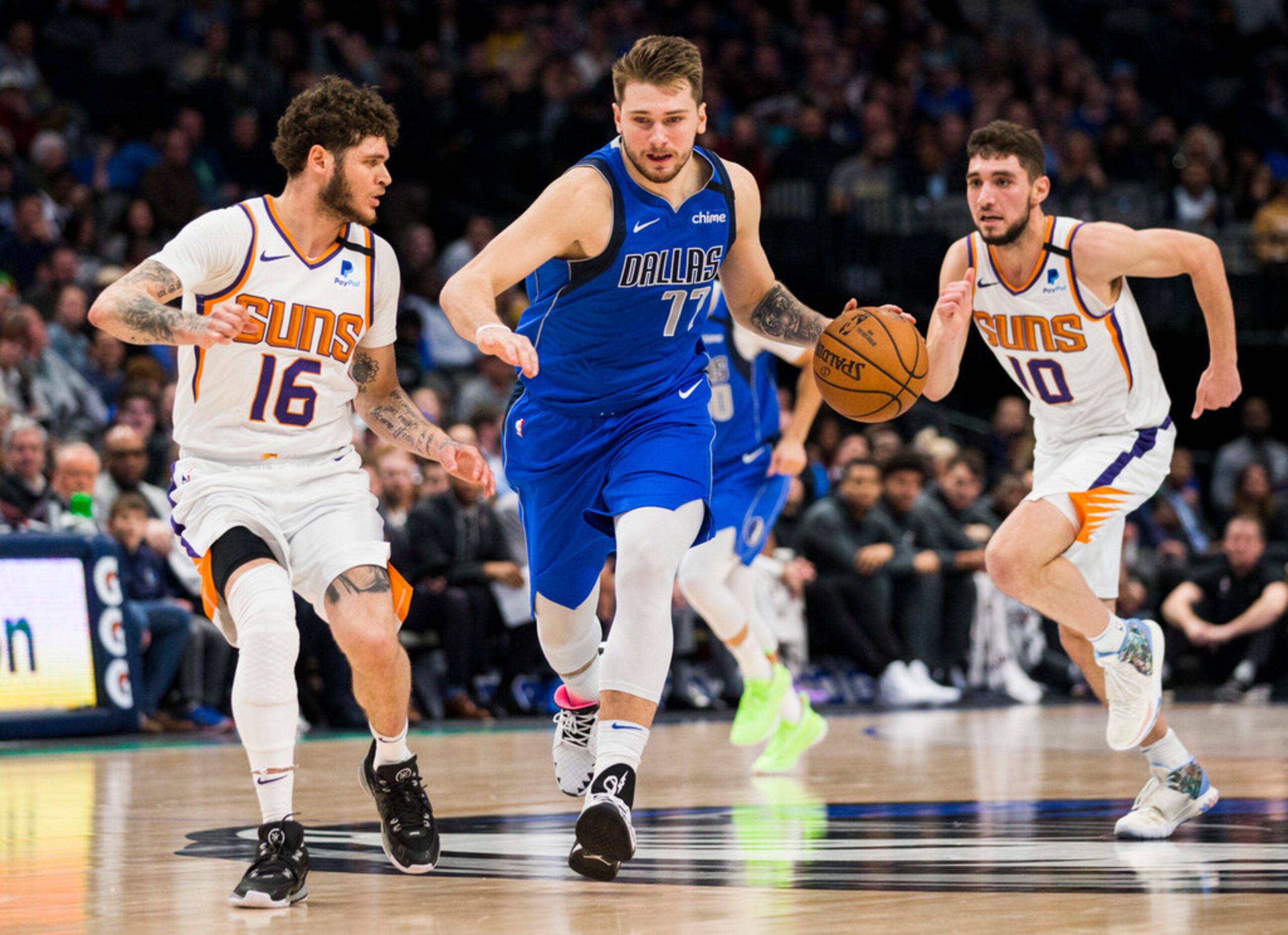 Dallas Mavericks guard Luka Doncic (77) gains control of a loose ball during the fourth...